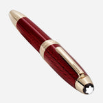 The Montblanc iconic snowcap emblem at the crown of the cap on the Montblanc Burgundy Red Meisterstück Solitaire Golden Hour LeGrand Fountain Pen.