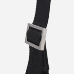 The BOSS logo engraved on the adjuster of the cross body strap on the BOSS Zair NS Zip Black Cross Body Bag with White Logo.