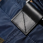 Black leather trims on the Paul Smith Multistripe Recycled Nylon Adjustable Tote Bag with Signature Logo Patch.
