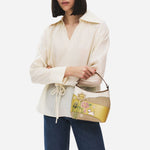 The grab handle on the Radley Spring Blooms Raffia and Leather Small Open Top Cross Body Bag.