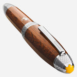 The yellow resin Montblanc snowcap emblem at the crown of the cap on the Montblanc Special Edition Great Masters Meisterstück Ferrari Tailor Made Classica Rollerball Pen.