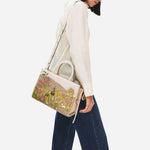 The Radley Spring Blooms Raffia and Leather Medium Ziptop Multiway Bag with the adjustable and detachable cross body strap.