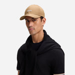 Model Wearing Zed Beige Cotton-Twill Cap with Embroidered White Logo from BOSS.