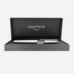 Léman Slim White & Rose Gold Rollerball Pen by Caran d'Ache.