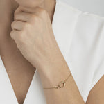 model wearing 18 KT. Yellow Gold Offspring Interlocking Bracelet from Georg Jensen.
