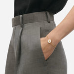 Model wearing Daisy White Enamel Bracelet from Georg Jensen.