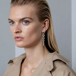 Model Wearing Sterling Silver Offspring Drop Earrings from Georg Jensen.