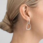 Model wearing Sterling Silver Offspring Interlocked Earrings from Georg Jensen.