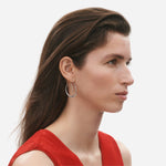 Model wearing Sterling Silver Offspring Double Earhoops from Georg Jensen.