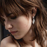 Model wearing Sterling Silver Reflect Drop Earrings from Georg Jensen.