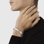 Man wearing Sterling Silver Reflect Bangle from Georg Jensen.