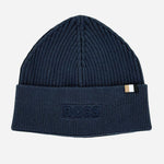 A dark navy blue ribbed knit beanie hat with a folded cuff. The cuff features an embossed BOSS logo patch on the left side and a small white and navy striped brand tag on the right side.