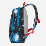A side view of a backpack featuring a black, blue, and white abstract splatter pattern, with a gray mesh back and red accents on the straps and zipper pulls.