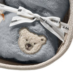 Close up of Lio penguin with rattle and bib gift set from Steiff.