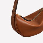 The Radley brand name has been embossed into the brown leather of this handbag.