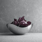 This Georg Jensen Stainless Steel Bloom Small Bowl is suitable to hold food.