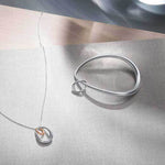This Georg Jensen Sterling Silver and 18 KT. Rose Gold Offspring Pendant will be presented inside a gift box.