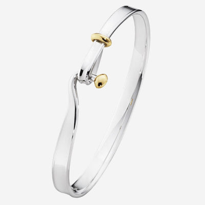 This is the Georg Jensen Sterling Silver & 18 KT. Yellow Gold Torun Bangle. 