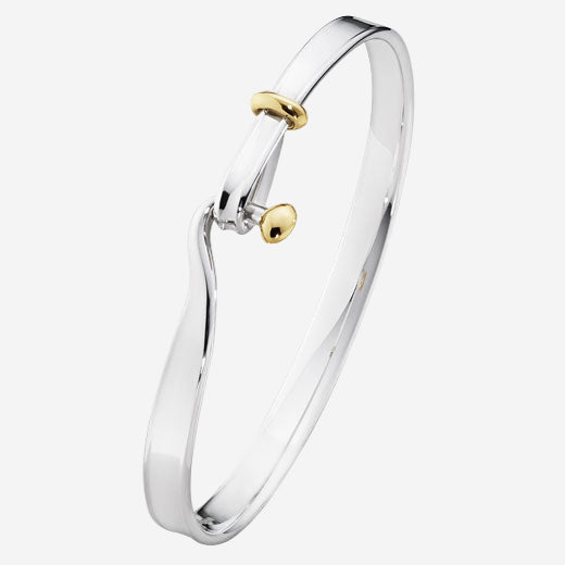 This is the Georg Jensen Sterling Silver & 18 KT. Yellow Gold Torun Bangle. 