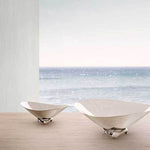 This beautiful stainless steel bowl by Georg Jensen has been designed with a mirror finish and modern clean lines.