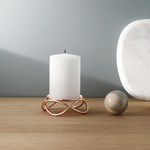 Georg Jensen's Candle with a rose gold candle holder.