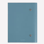 The Montblanc brand name has been embossed on the back of this blue leather envelope holder.