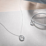 This Georg Jensen Sterling Silver Offspring Interlocked Pendant is simple but bold.